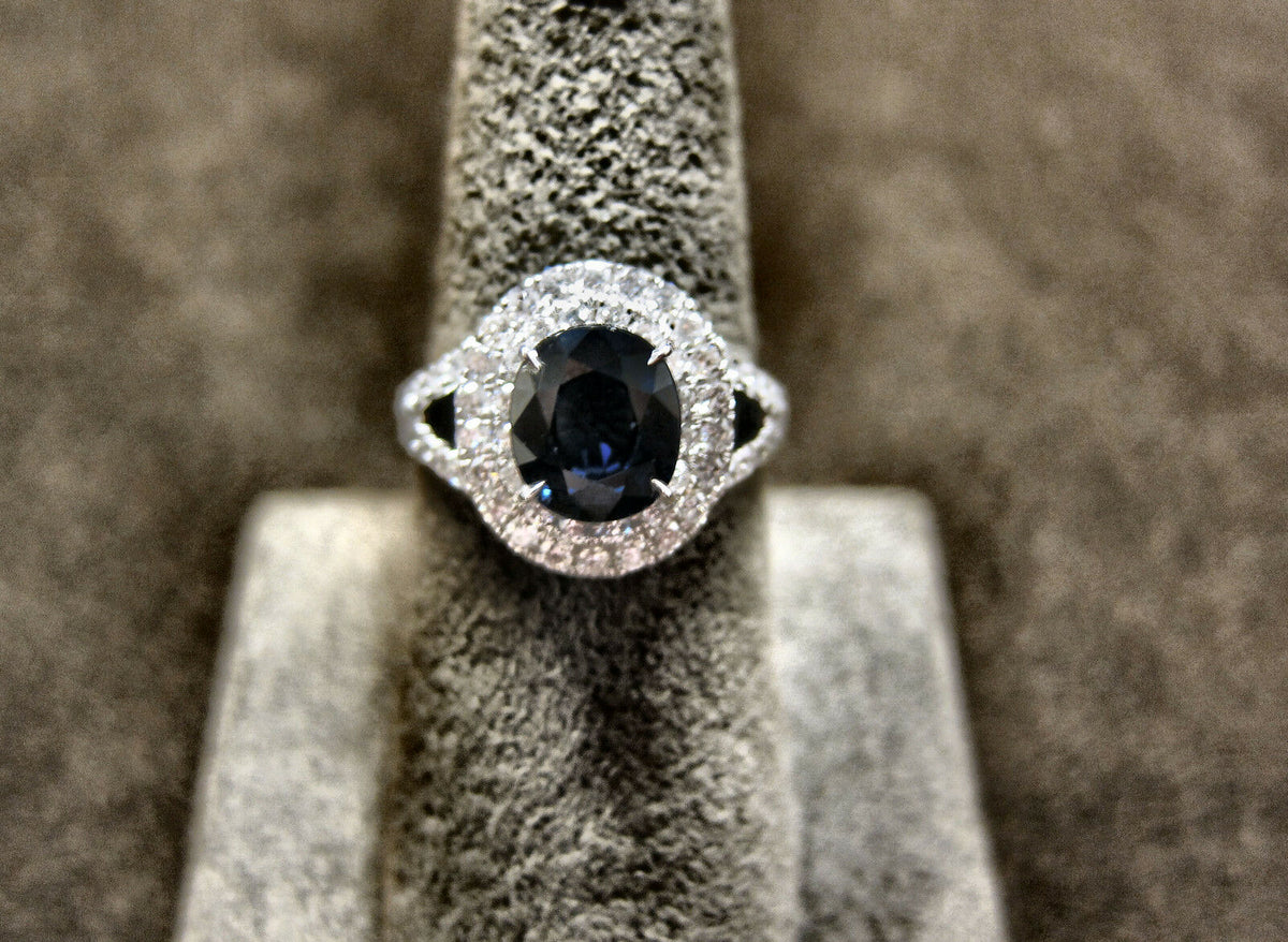 OVAL DEEP BLUE SAPPHIRE ROUND BRILLIANT PRONG SET DIAMOND