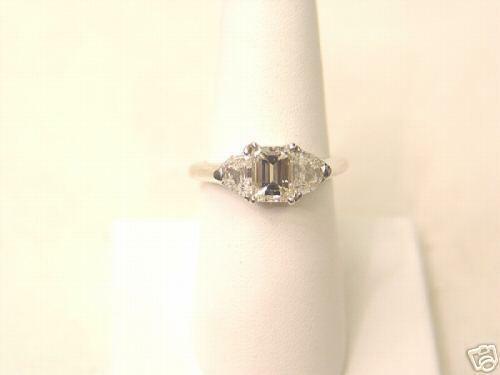 EMERALD CUT DIAMOND IN THE CENTER 4 PRONGS 1.50 CT, SIDES 2 HALF MOON DIAMONDS