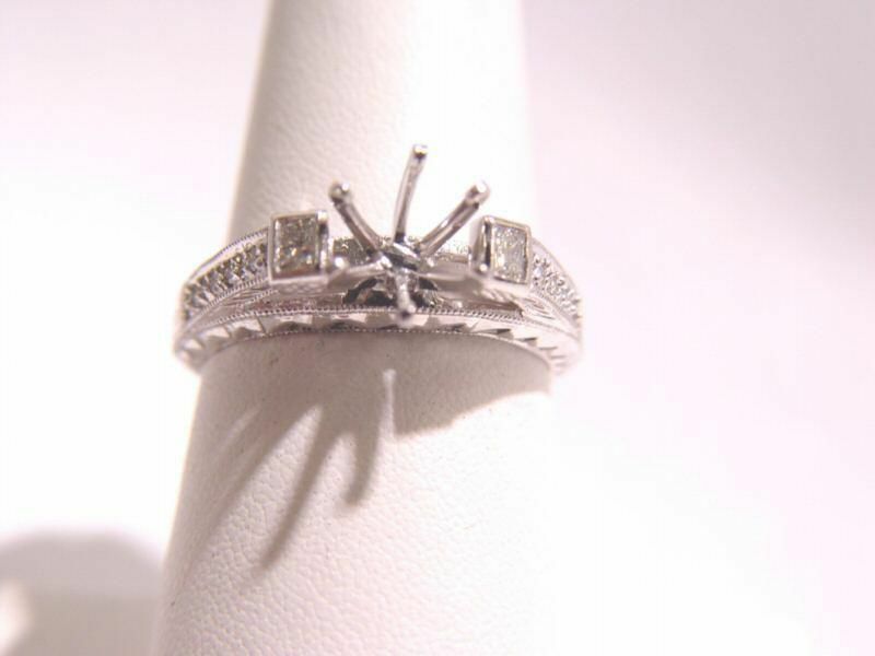 ANTIQUE STYLE SETTING ROUND BRILLIANT AND 2 PRINCESS CUT