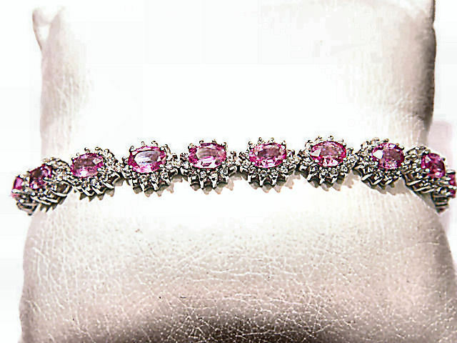 17 OVAL PINK SAPPHIRES SET WITH ROUND BRILLIANT CUT DIAMONDS
