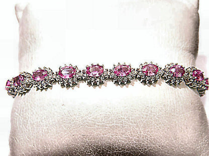 17 OVAL PINK SAPPHIRES SET WITH ROUND BRILLIANT CUT DIAMONDS