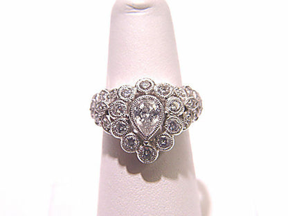 CENTER PEAR CUT DIAMOND SIDE ROUND BRILLIANT CUT DIAMOND COCKTAIL RING BAND