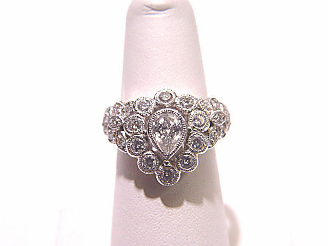 CENTER PEAR CUT DIAMOND SIDE ROUND BRILLIANT CUT DIAMOND COCKTAIL RING BAND