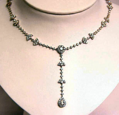 10.05 CTTW ROUND BRILLIANT CUT AND 1 PEAR CUT .38 CT SET IN THE CENTER DIAMOND