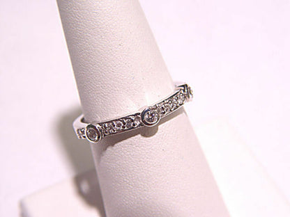 DIAMONDS PRONG AND BEZEL SET ON THE TOP OF THE RING