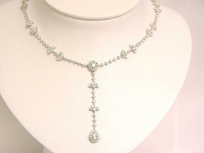 10.05 CTTW ROUND BRILLIANT CUT AND 1 PEAR CUT .38 CT SET IN THE CENTER DIAMOND