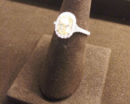 CERTIFIED OVAL FANCY LIGHT YELLOW DIAMOND HALO AND SIDE ROUND DIAMOND RING