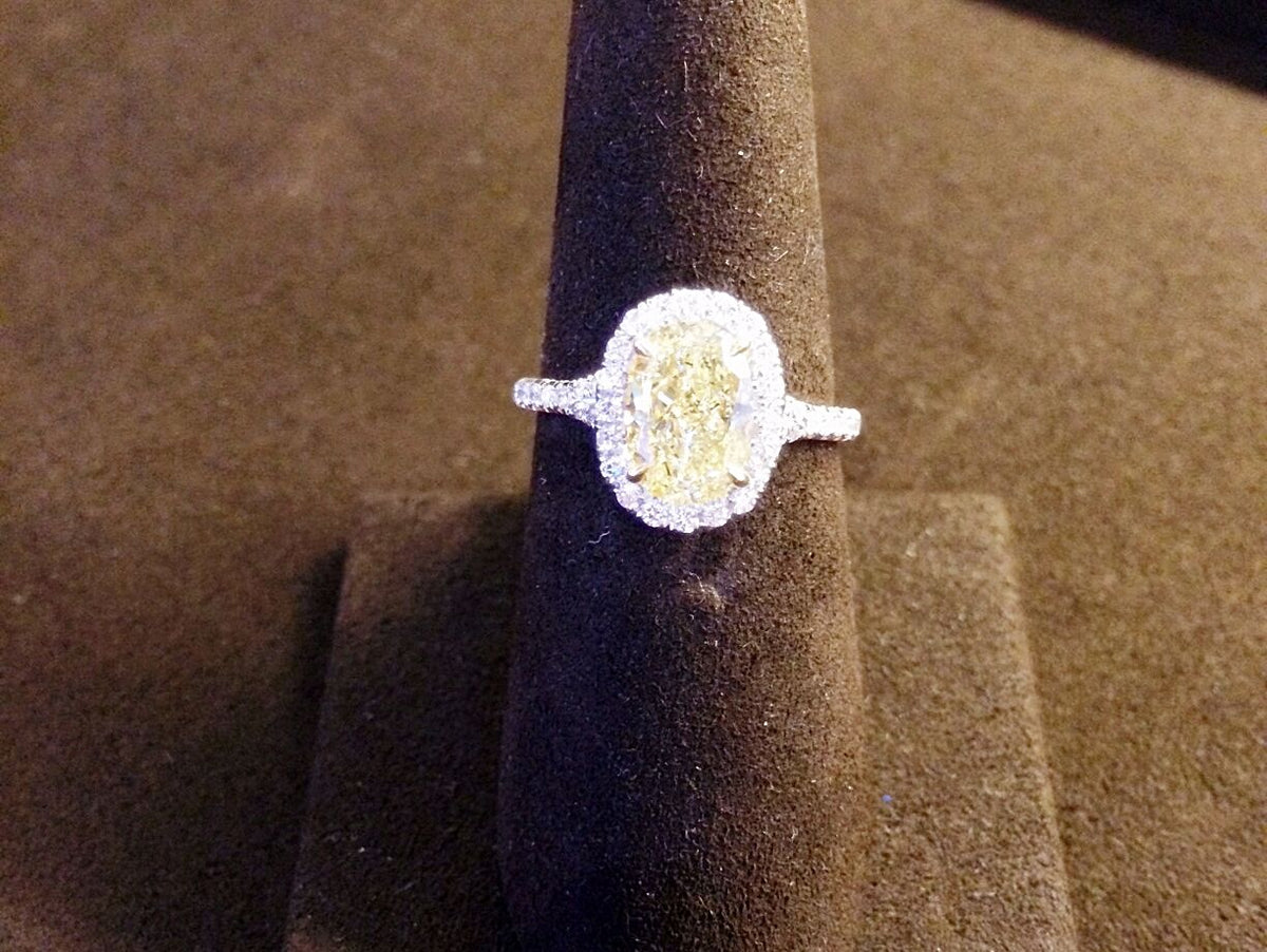 CERTIFIED OVAL FANCY LIGHT YELLOW DIAMOND HALO AND SIDE ROUND DIAMOND RING