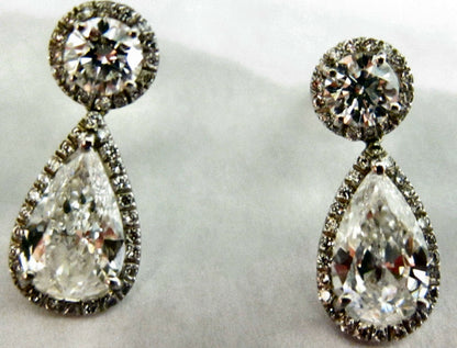 GIA CERTIFIED PEAR SHAPE 1.56CT F SI1, GIA 1.52CT F SI1 AND SET ROUND DIAMOND