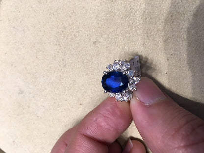 OVAL BLUE SAPPHIRE SET WITH ROUND BRILLIANT MARQUISE