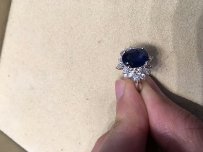 OVAL BLUE SAPPHIRE SET WITH ROUND BRILLIANT MARQUISE