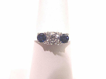 .80 CT 2 SAPPHIRE SHAPE SIDE STONE 1 ROUND BRILLIANT SH .61 CT DIAMOND 18 K GOLD