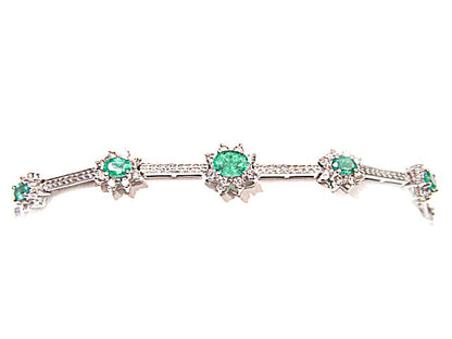GRADUATED FROM CENTER 9 OVAL GREEN EMERALDS SET WITH ROUND BRILLIANT CUT DIAMOND