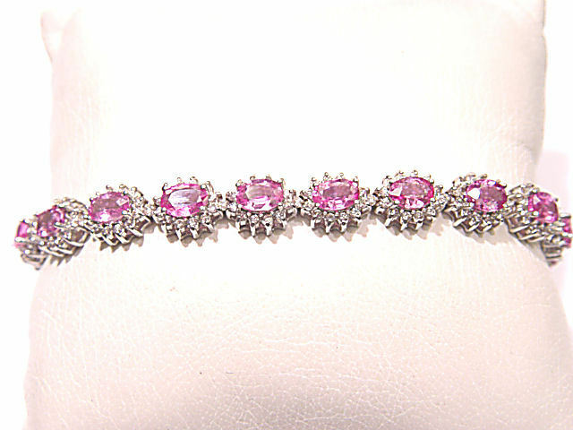 17 OVAL PINK SAPPHIRES SET WITH ROUND BRILLIANT CUT DIAMONDS
