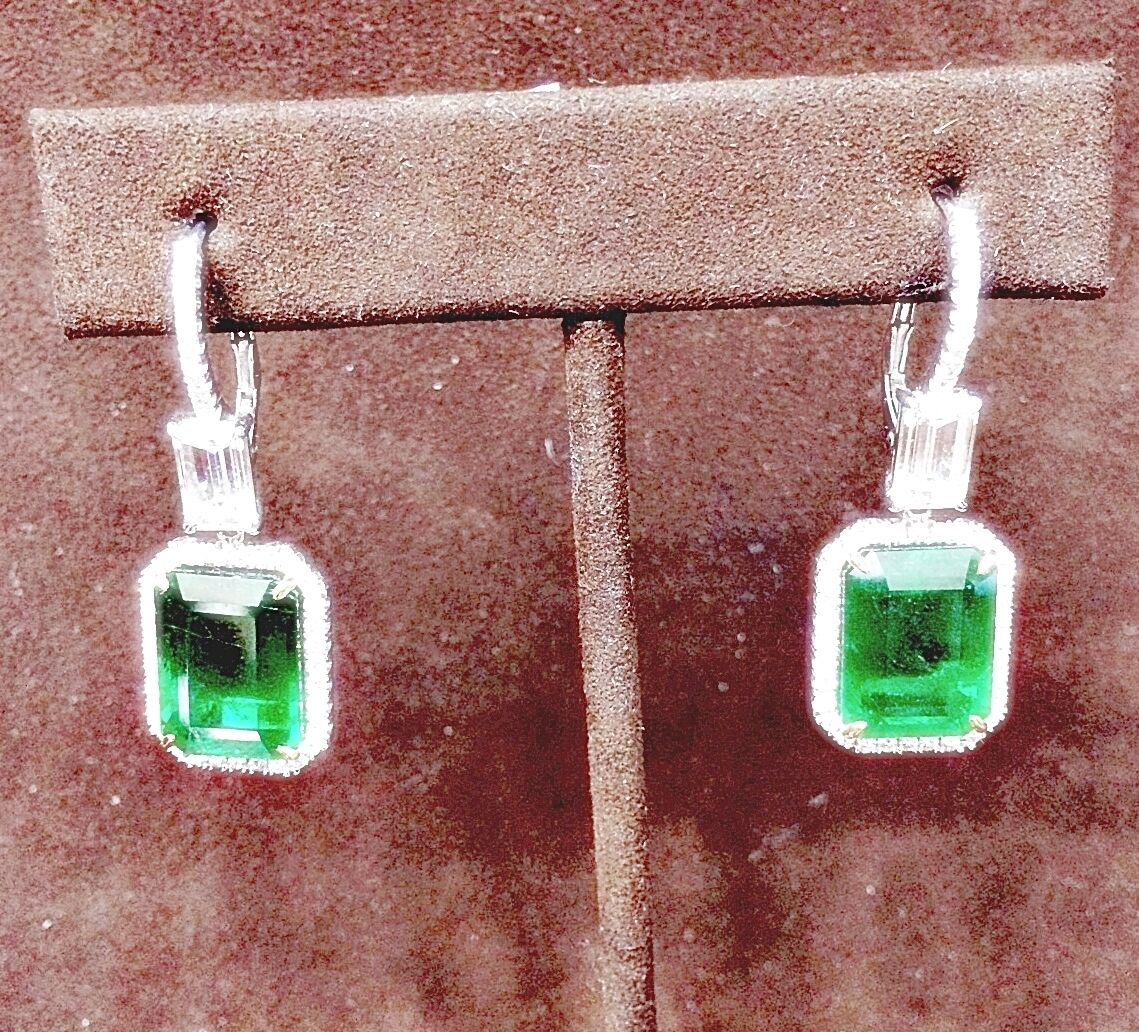 EMERALD 2 EMERALD SHAPE DIAMOND EMERALD SHAPE AND ROUND DROP HALO