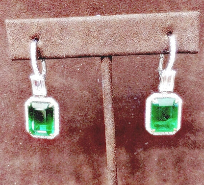 EMERALD 2 EMERALD SHAPE DIAMOND EMERALD SHAPE AND ROUND DROP HALO