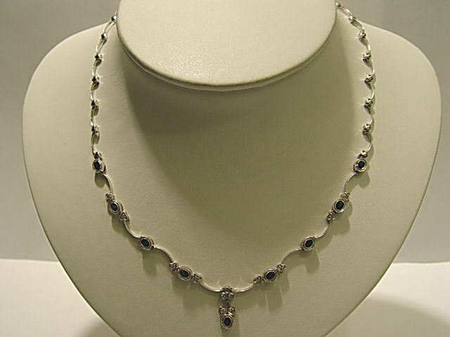 9 OVAL BLUE SAPPHIRE SET WITH ROUND BRILLIANT DIAMOND