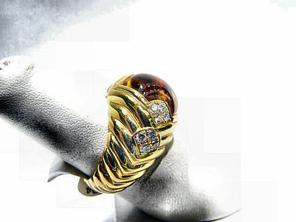 CABOCHON CITRINE SET WITH SIXTEEN ROUND BRILLIANT SHAPE DIAMOND