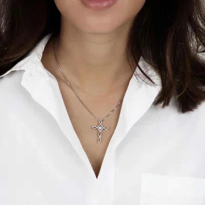 Dancing Created White Sapphire and 0.15 CT. T.W. Diamond Cross Pendant in Sterli