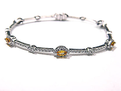 6 MARQUISE CUT YELLOW SAPPHIRES SET WITH ROUND BRILLIANT