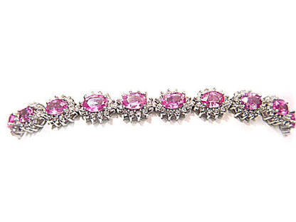 17 OVAL PINK SAPPHIRES SET WITH ROUND BRILLIANT CUT DIAMONDS