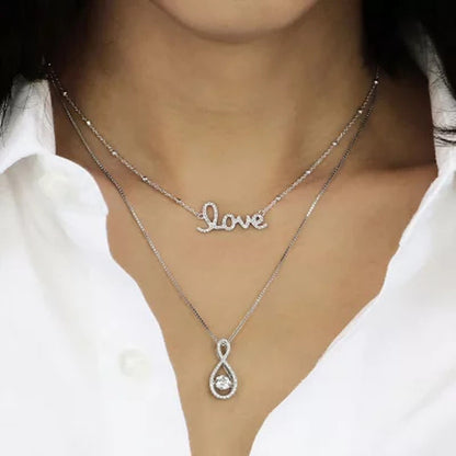 Dancing Lab Created White Sapphire and 0.12 CT. T.W. Diamond Infinity Pendant in