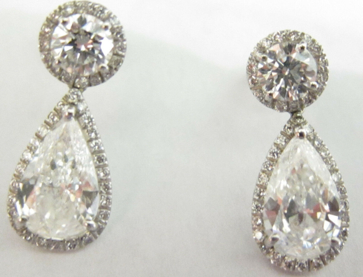 GIA CERTIFIED PEAR SHAPE 1.56CT F SI1, GIA 1.52CT F SI1 AND SET ROUND DIAMOND