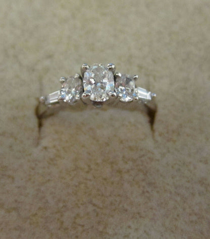 DIAMOND THREE OVAL CENTER SET SIDE TWO TAPERED BAGUETTE SHAPE ENGAGEMENT RING