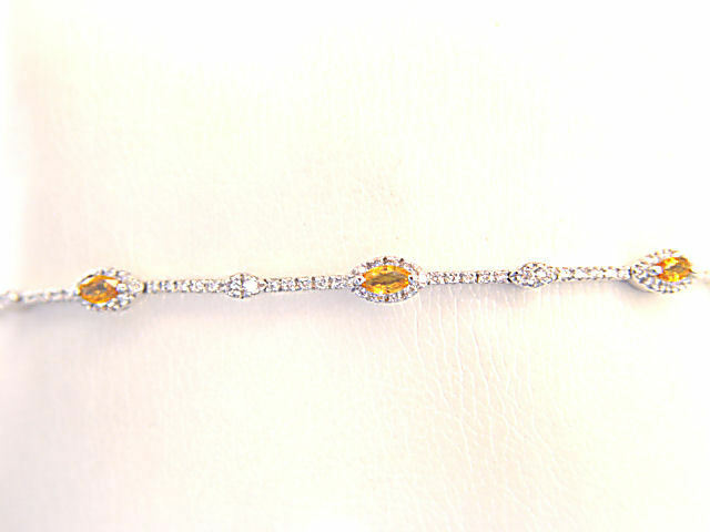 6 MARQUISE CUT YELLOW SAPPHIRES SET WITH ROUND BRILLIANT