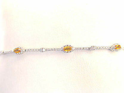6 MARQUISE CUT YELLOW SAPPHIRES SET WITH ROUND BRILLIANT