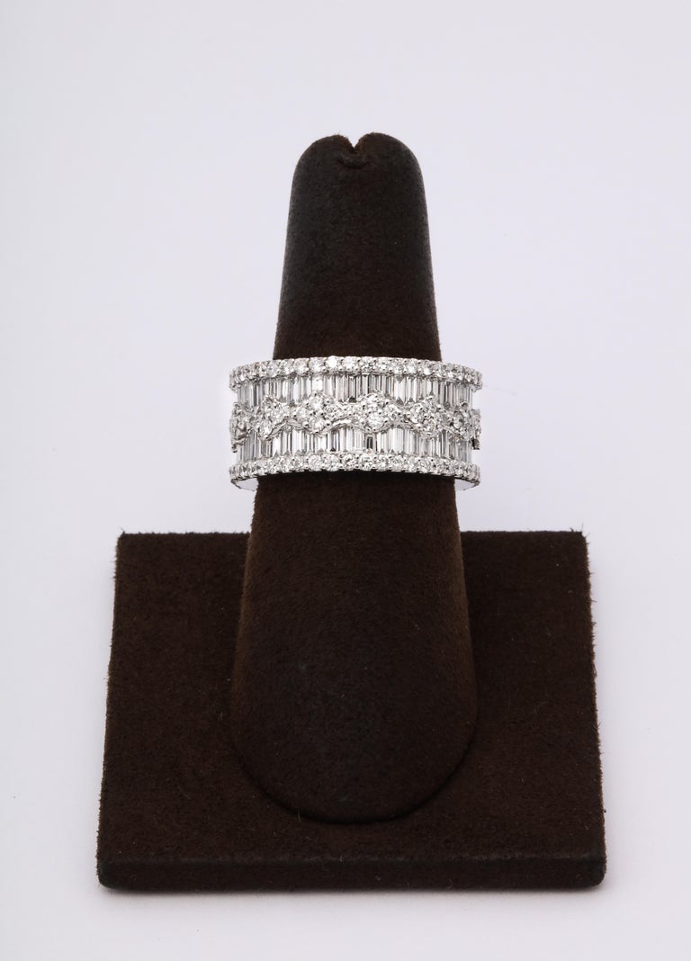 https://a.1stdibscdn.com/wide-baguette-and-round-diamond-band-for-sale-picture-4/j_415/1606754927586/6R1A9891_master.jpg?width=768