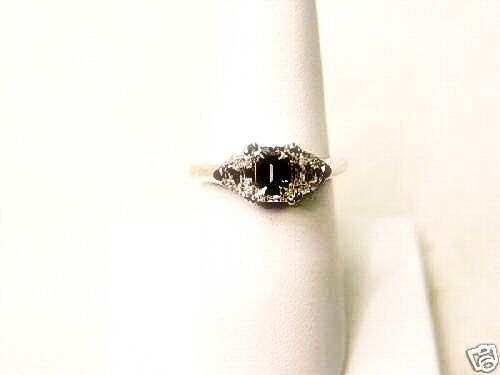 EMERALD CUT DIAMOND IN THE CENTER 4 PRONGS 1.50 CT, SIDES 2 HALF MOON DIAMONDS