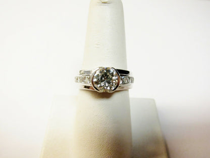 CERTIFIED ROUND BRILLIANT HALF BEZEL SET DIAMOND SIDE CHANNEL ENGAGEMENT RING