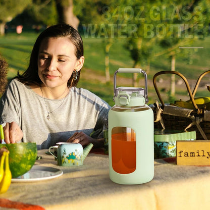 84Oz Water Bottle Glass with Stainless Steel Handle Large Water Bottle with Time Markers and Silicone Sleeve Half Gallon Water Jug BPA Free for Gym Daily Use, Light Green